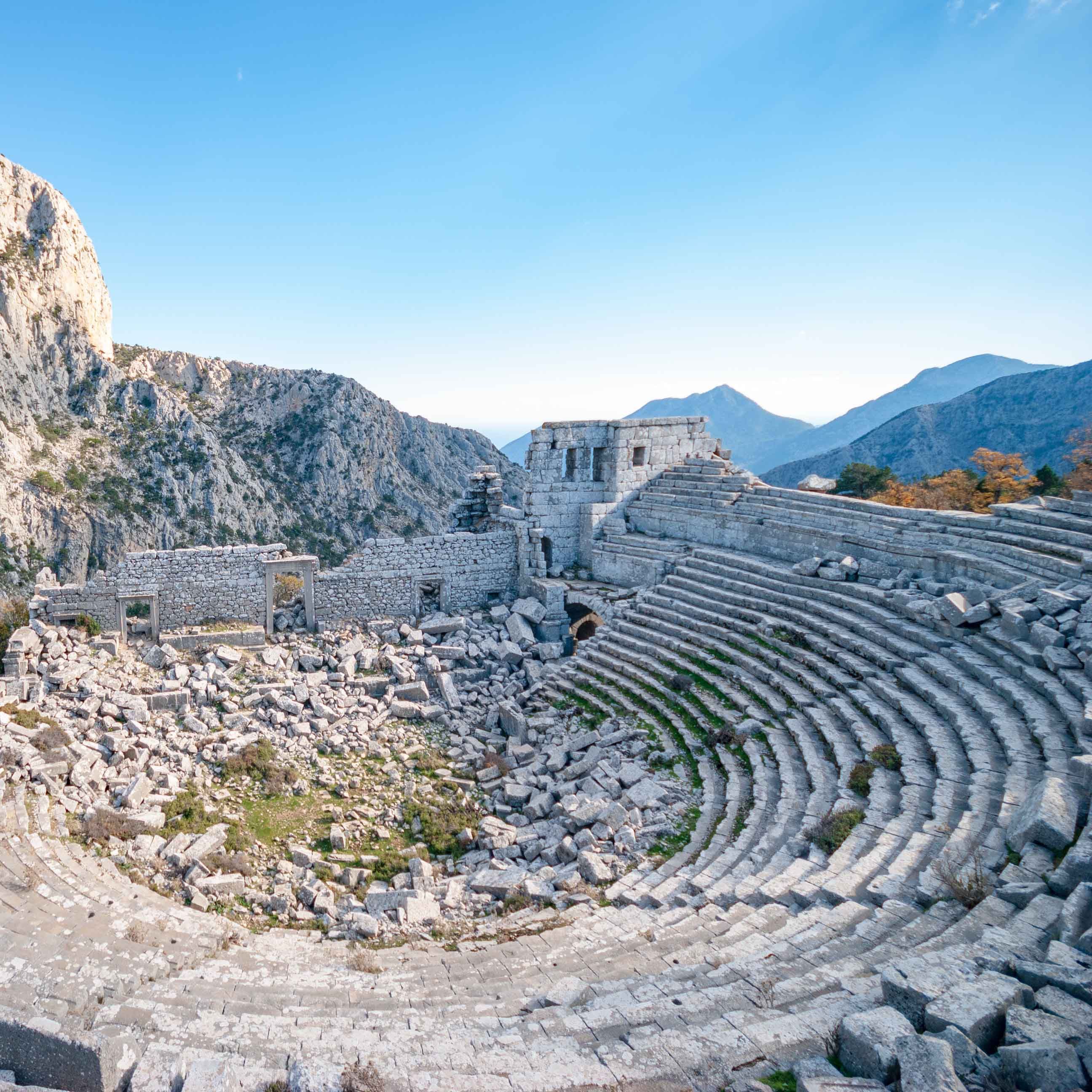 View of Termessos Ancient Theatre with mountains in the backdrop